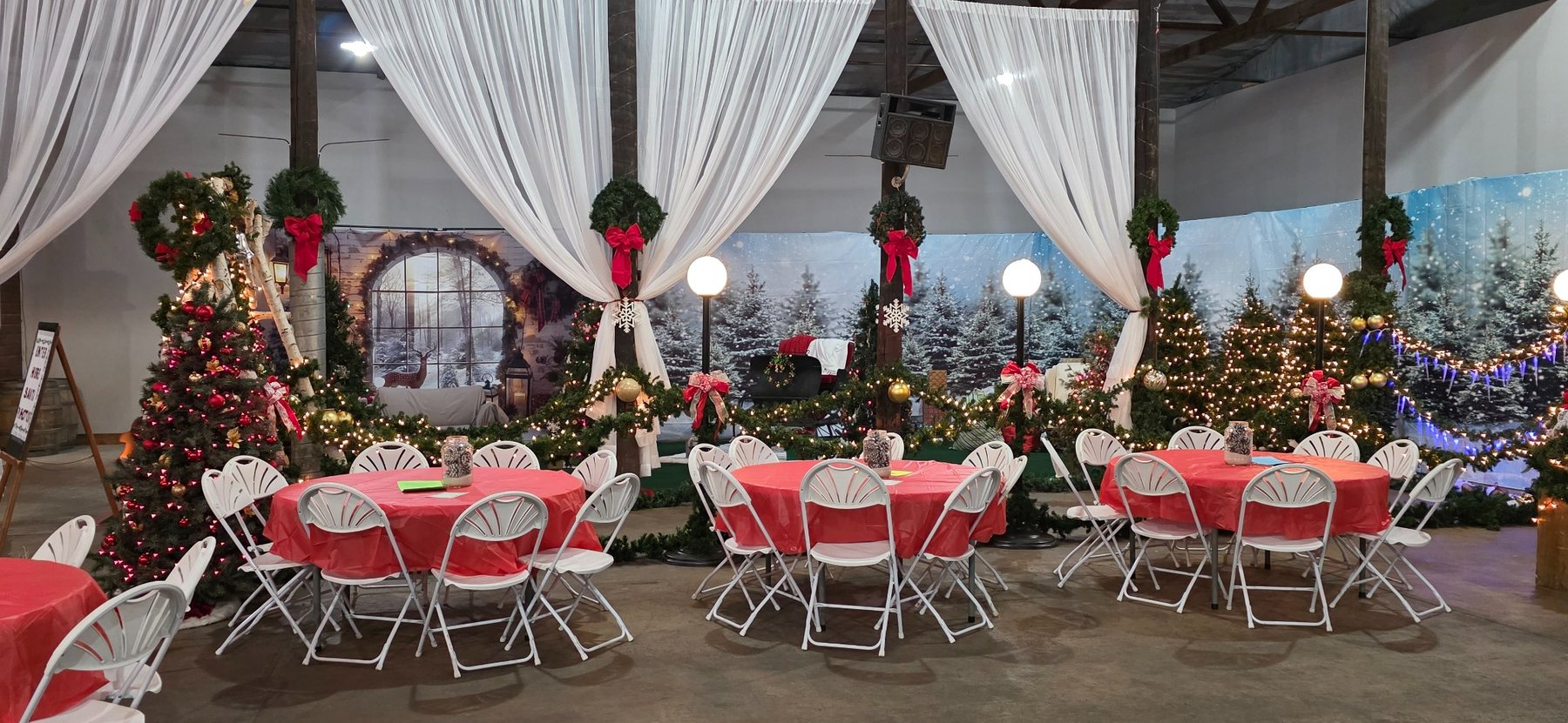 Christmas Time seating area surrounded by trees, lights and winter decorations