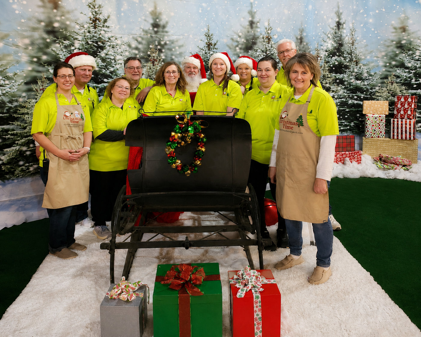 Christmas Time volunteers gathered together in front of a winter backdrop